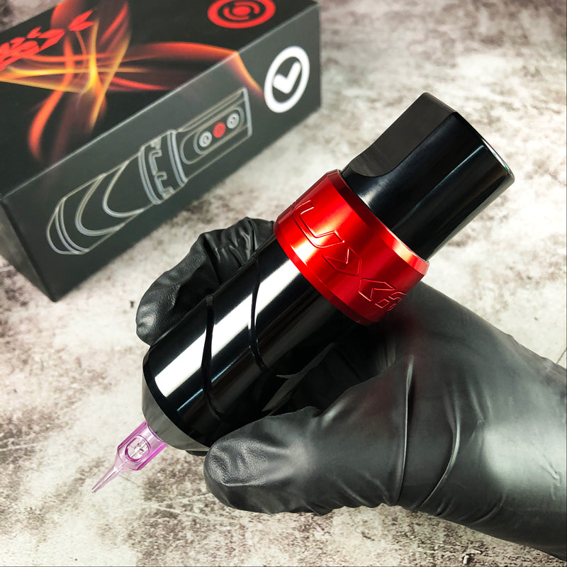 Close-up of FluxMax Wireless Pen Tattoo Machine in red color with adjustable voltage control.